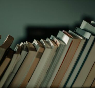 Books leaning on a shelf in Library