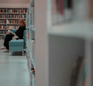 Girl reading on chair in Library