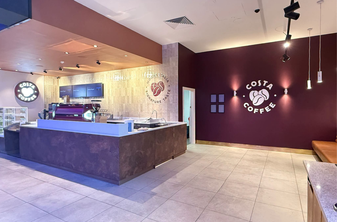 Costa Coffee promotional image featuring a Costa Coffee shop with a signage